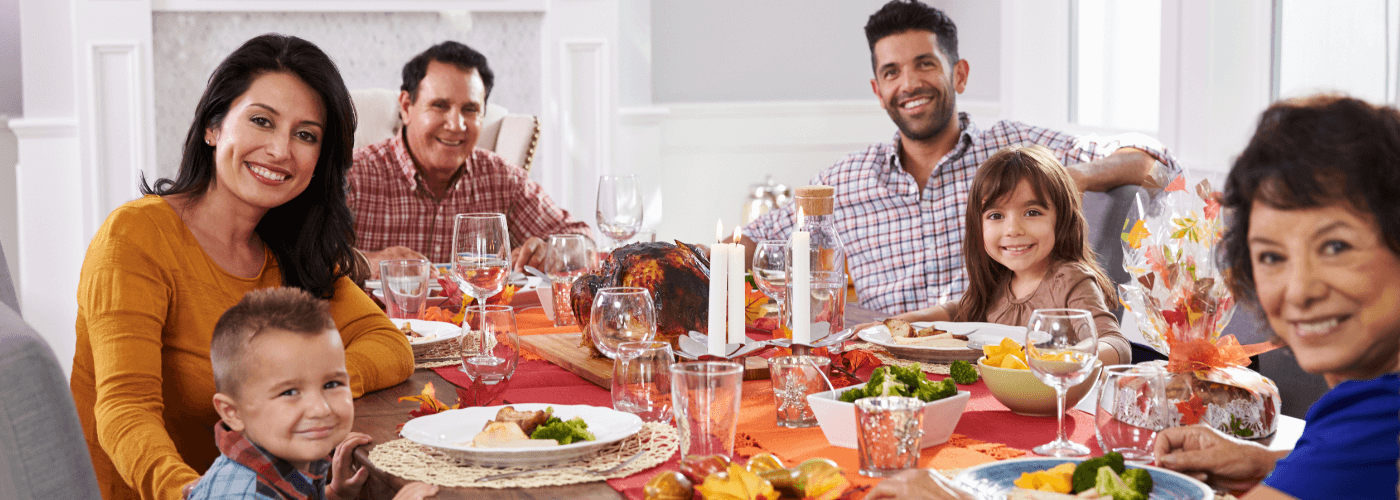 family with grandparents enjoying meal at the dinner table