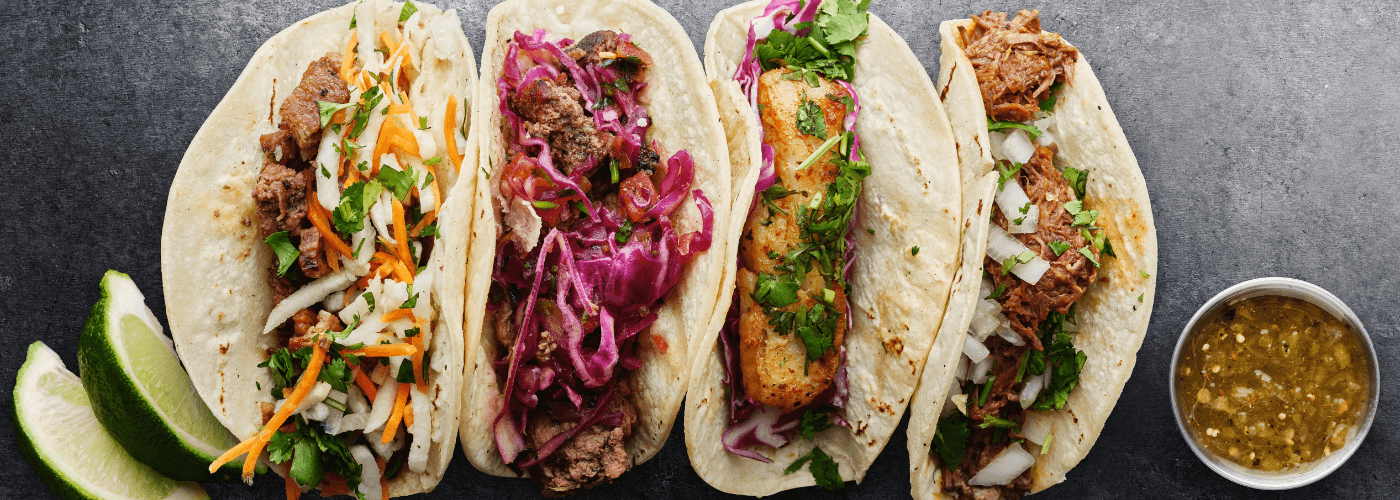 delicious street tacos accompanied by salsa served on plate