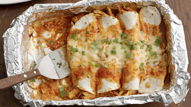 enchiladas in a tray wrapped in aluminum foil
