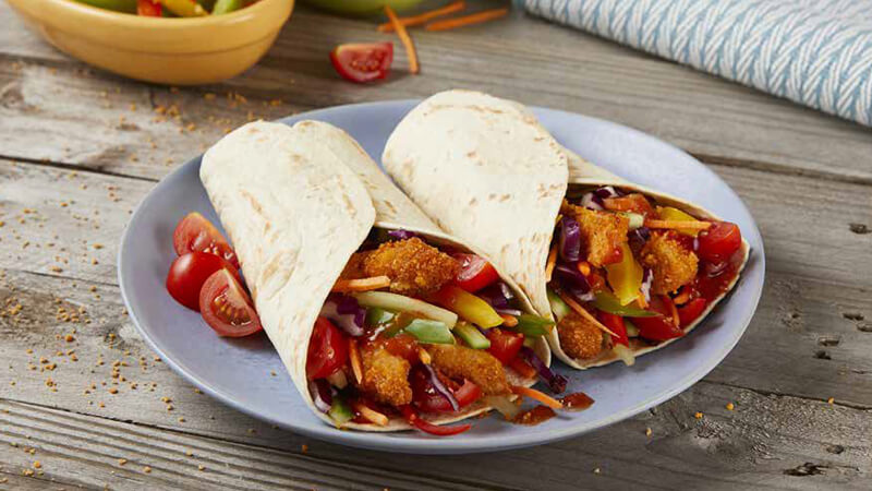 Crunchy Rainbow Chicken Fajitas served in a light blue plate