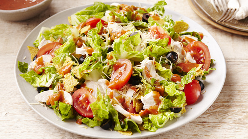 chicken fiesta taco salad served in a white plate